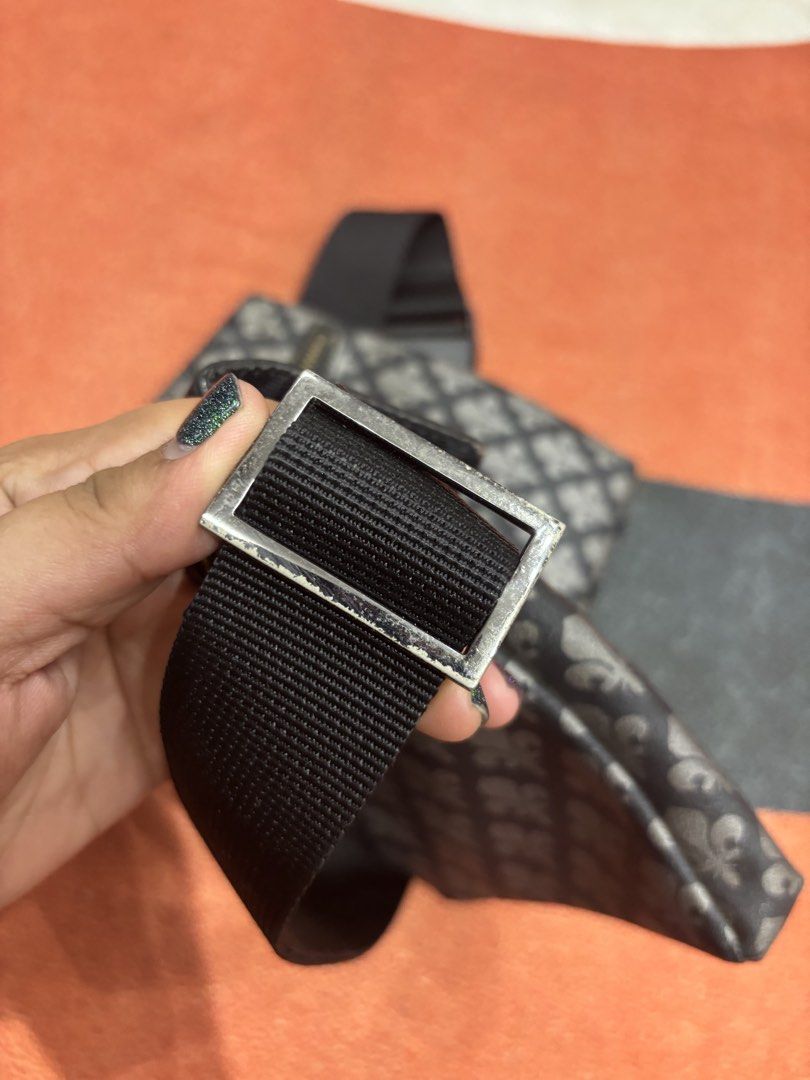 Patrick Cox Fleur-de-lis Pattern Waist Bag (Category: Luxury Bags & Wallets) located in Alicia. Submitted by thriftbagph (Listing ID 1462416917, Image 3). Description: - Authentic Patrick Cox waist bag - Signature fleur-de-lis pattern - Color: Black and Grey - Adjustable strap with buckle closure - Main zippered compartment - Front flap pocket with leather detail - Ideal for keeping your essentials easily accessible - sign of usage on strap.