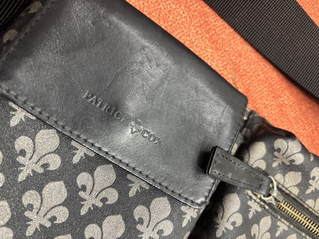 Patrick Cox Fleur-de-lis Pattern Waist Bag (Category: Luxury Bags & Wallets) located in Alicia. Submitted by thriftbagph (Listing ID 1462416917, Image 2). Description: - Authentic Patrick Cox waist bag - Signature fleur-de-lis pattern - Color: Black and Grey - Adjustable strap with buckle closure - Main zippered compartment - Front flap pocket with leather detail - Ideal for keeping your essentials easily accessible - sign of usage on strap.