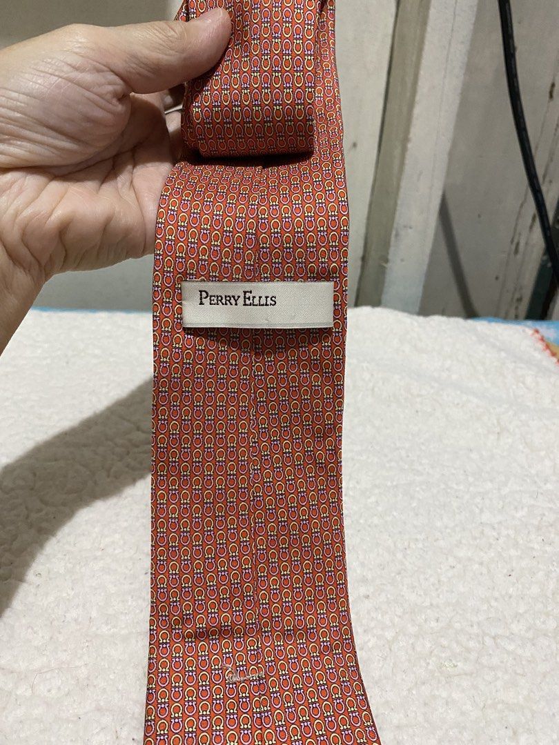 Perry Ellis Orange Patterned Silk Tie (Category: Ties) located in Manila. Submitted by resi.diaz (Listing ID 1462422830, Image 3). Description: - Brand: Perry Ellis - Color: Orange - Material: Silk - Style: Adds a touch of sophistication to any outfit.