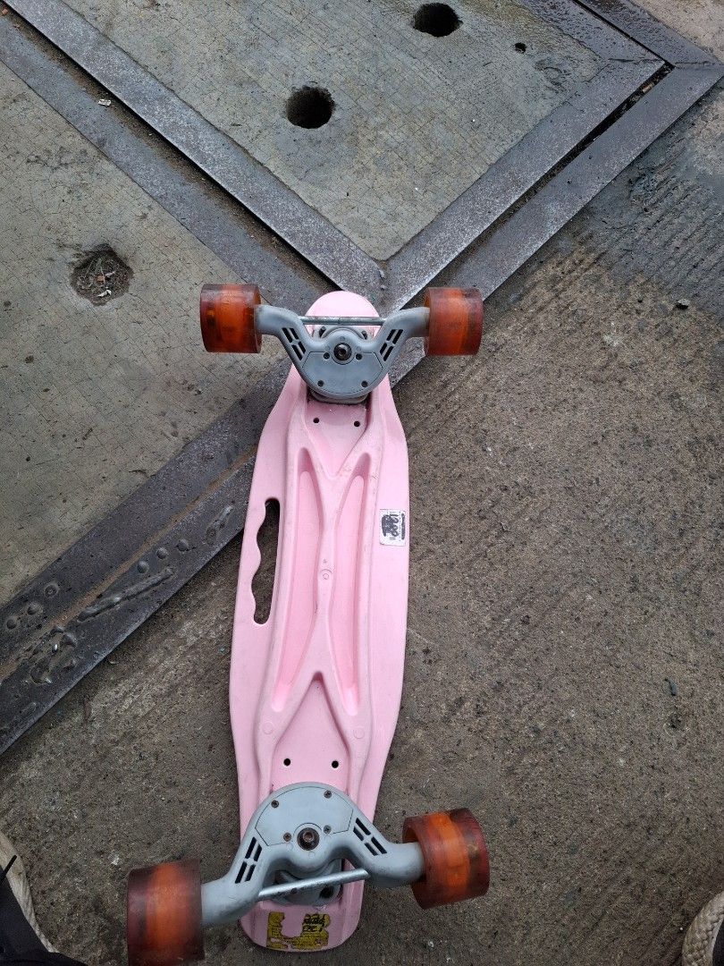 Pink Penny Board Skateboard (Category: Skates, Rollerblades & Scooters) located in Manila. Submitted by rocksolid227 (Listing ID 1462319907, Image 2). Description: - Pink penny board - Perfect for cruising - Wheels are slightly worn but still roll smoothly - Deck has minor scuffs from normal use - Features a convenient handle cut-out for easy carrying - Ready for its next adventure!.