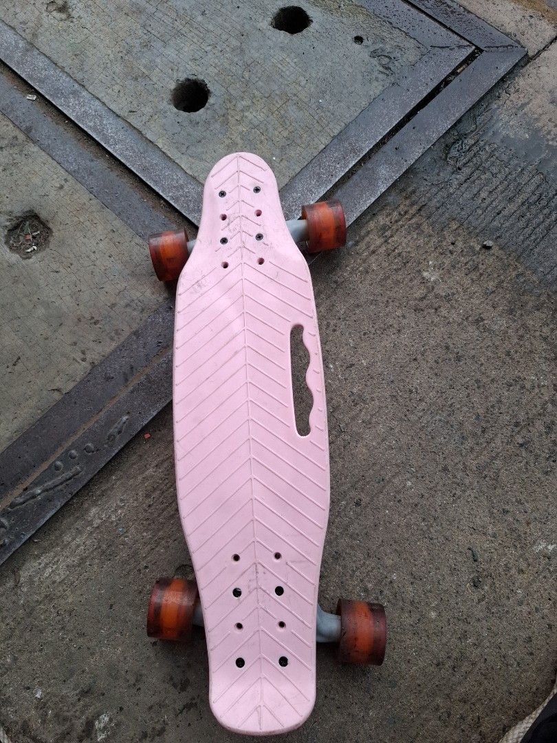 Pink Penny Board Skateboard (Category: Skates, Rollerblades & Scooters) located in Manila. Submitted by rocksolid227 (Listing ID 1462319907, Image 1). Description: - Pink penny board - Perfect for cruising - Wheels are slightly worn but still roll smoothly - Deck has minor scuffs from normal use - Features a convenient handle cut-out for easy carrying - Ready for its next adventure!.