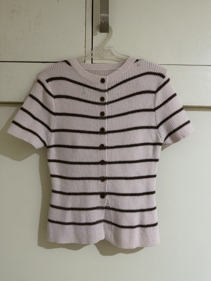 Pink Striped Button-Up Knit (Category: Coats, Jackets and Outerwear) located in Antipolo. Submitted by elmclothing (Listing ID 1462398321, Image 1). Description: - Pink short-sleeved knit cardigan - Features dark brown stripes - Button-up front closure - Ribbed texture for a cozy feel - Estimated size: Small to Medium - Versatile for layering or wearing solo.
