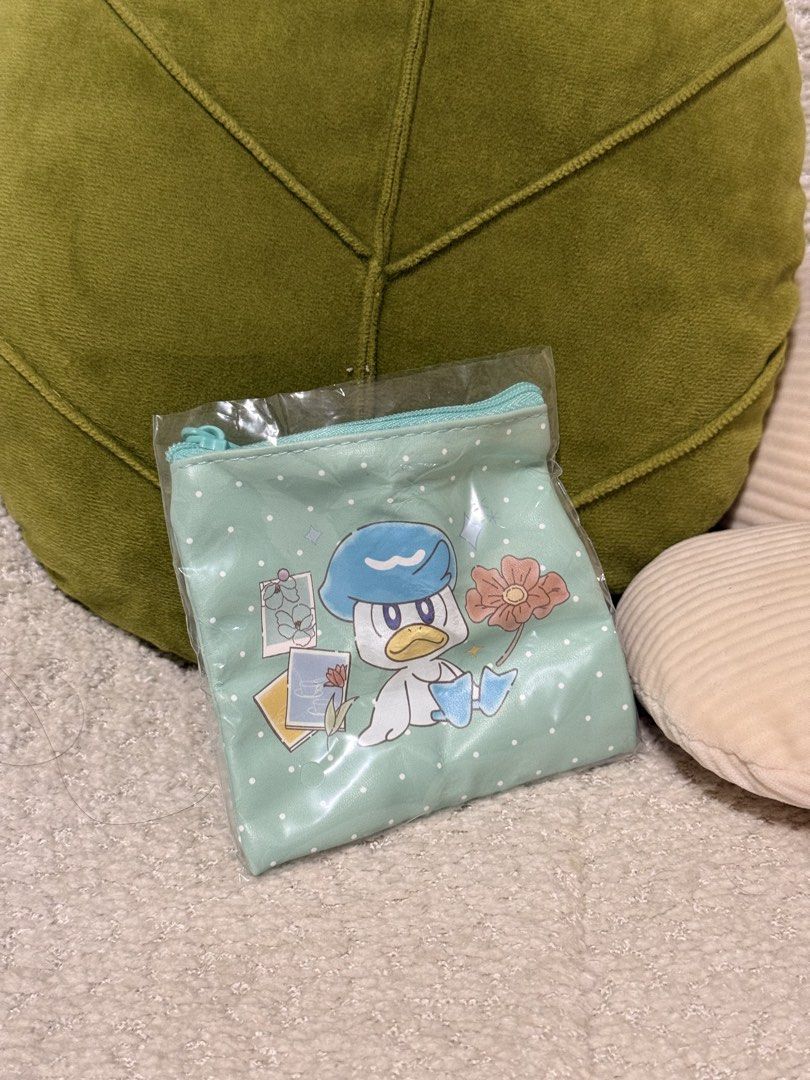 Pokemon Quaxly Coin Pouch Mint Green (Category: Other Stationery & Craft) located in Manila. Submitted by bernardine32364 (Listing ID 1462292287, Image 1). Description: - Pokemon Gashapon Pouch - Adorable mint green pouch featuring Quaxly - Secure zipper closure - Perfect for coins, cards, or small essentials - Fun and cute Pokemon-themed design - Comes in original packaging - Great gift for any Pokemon fan.