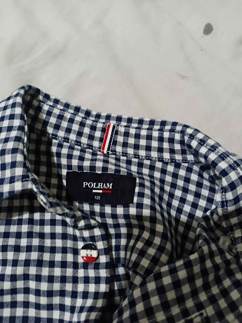POLHAM Gingham Check Long Sleeve Shirt (Category: Tshirts & Polo Shirts ) located in Las Pinas. Submitted by brighteagle_f7df30 (Listing ID 1462386165, Image 3). Description: - Brand: POLHAM - Style: Long sleeve shirt - Pattern: Classic navy and white gingham check - Closure: Button-up front with white buttons - Size: Tagged 120 - Occasion: Versatile for casual wear or dressing up.