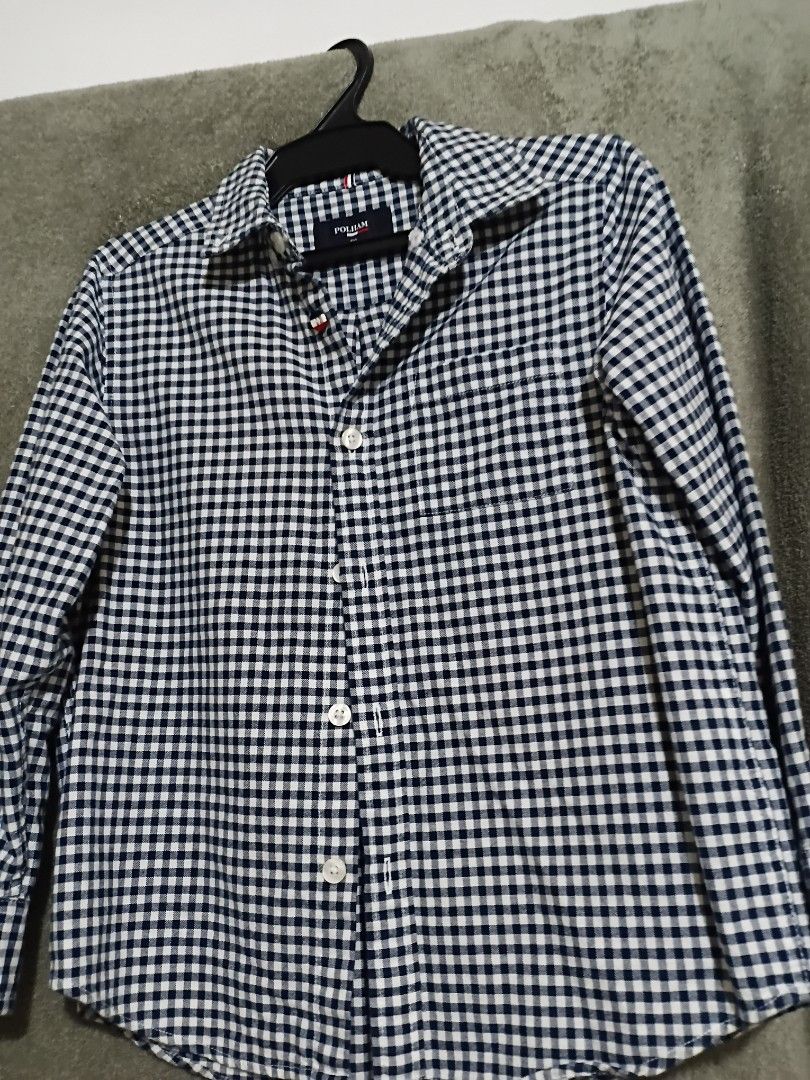 POLHAM Gingham Check Long Sleeve Shirt (Category: Tshirts & Polo Shirts ) located in Las Pinas. Submitted by brighteagle_f7df30 (Listing ID 1462386165, Image 1). Description: - Brand: POLHAM - Style: Long sleeve shirt - Pattern: Classic navy and white gingham check - Closure: Button-up front with white buttons - Size: Tagged 120 - Occasion: Versatile for casual wear or dressing up.