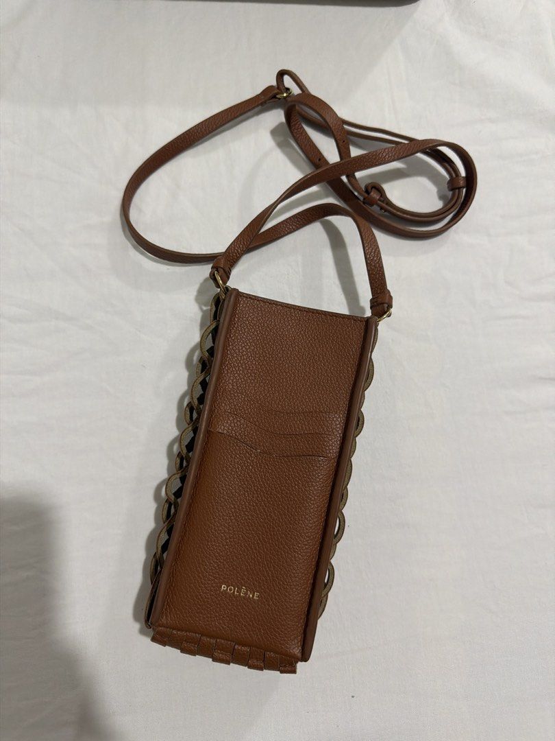 Polene Phone Bag (Category: Luxury Bags & Wallets) located in Manila. Submitted by itsnellyyyy (Listing ID 1462368173, Image 3). Description: - Brand: Polène - Onda - Cognac - Material: Brown woven leather - Strap: Long and adjustable - Wearability: Crossbody or shoulder - Capacity: Fits phone and small essentials - Ideal for: Traveling light - Bought in Polène Paris with receipt Rfs: declutterring Negotiable .