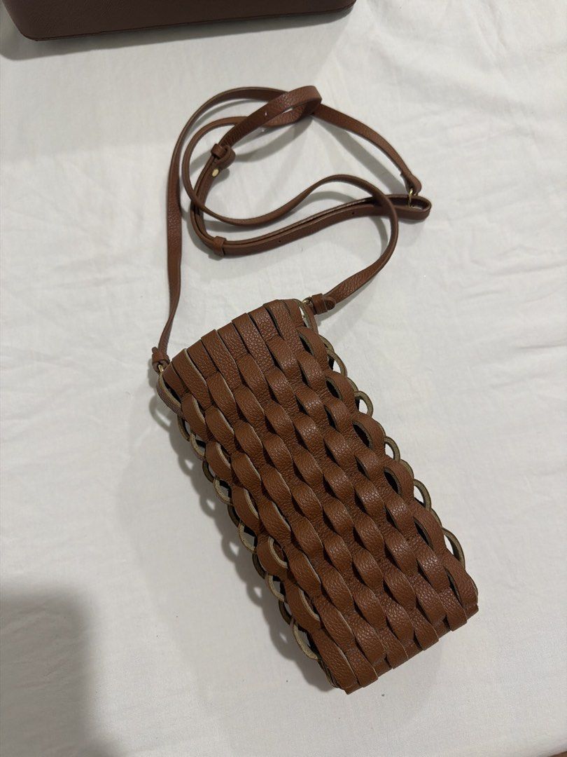 Polene Phone Bag (Category: Luxury Bags & Wallets) located in Manila. Submitted by itsnellyyyy (Listing ID 1462368173, Image 2). Description: - Brand: Polène - Onda - Cognac - Material: Brown woven leather - Strap: Long and adjustable - Wearability: Crossbody or shoulder - Capacity: Fits phone and small essentials - Ideal for: Traveling light - Bought in Polène Paris with receipt Rfs: declutterring Negotiable .