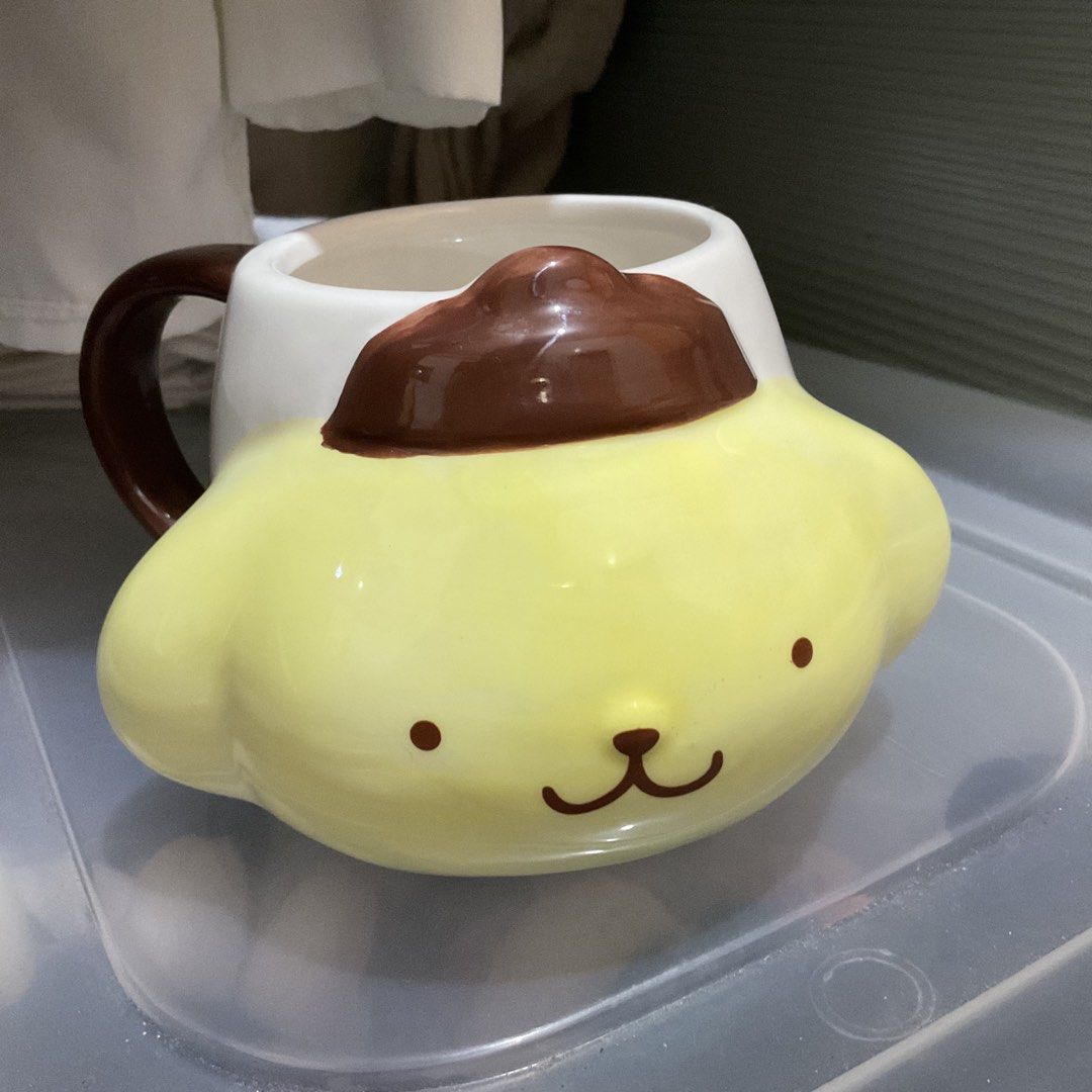 Pompompurin Ceramic Mug Sanrio (Category: Coffee & Tea Tableware) located in Naga. Submitted by asrid.32 (Listing ID 1462295997, Image 1). Description: - Adorable Pompompurin mug - Yellow design with brown hat and handle - Features "POMPOMPURIN" text - Includes quote: "Special days are to be enjoyed with special friends." - Ideal for morning coffee or tea - A must-have for any Pompompurin fan.