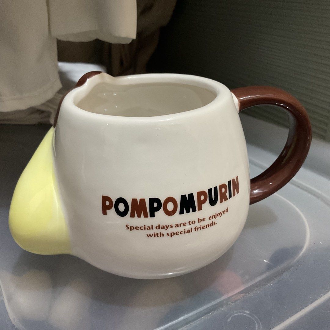 Pompompurin Ceramic Mug Sanrio (Category: Coffee & Tea Tableware) located in Naga. Submitted by asrid.32 (Listing ID 1462295997, Image 2). Description: - Adorable Pompompurin mug - Yellow design with brown hat and handle - Features "POMPOMPURIN" text - Includes quote: "Special days are to be enjoyed with special friends." - Ideal for morning coffee or tea - A must-have for any Pompompurin fan.