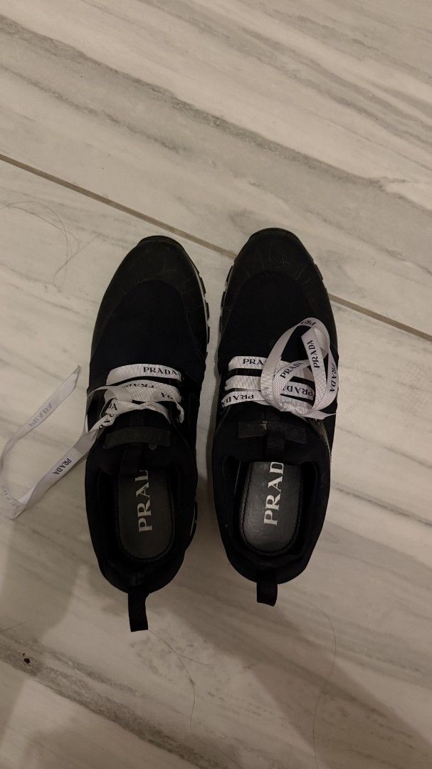 Prada Black Sneakers with Logo Laces (Category: Sneakers) located in Cavite. Submitted by kristiecasem (Listing ID 1462295486, Image 2). Description: - AutPrada Black Cloudbust Sneakers ₱3,500 Original retail price: approx. ₱40,000+ Size 6 Preloved Prada Cloudbust sneakers in black with Prada ribbon laces. Well-used condition with visible signs of wear, especially on the soles. Please see photos for actual condition. Selling as part of closet dec