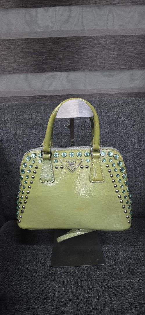 Prada Lime Green Patent Leather Studded Handbag (Category: Shoulder Bags) located in General Trias. Submitted by roselle2230 (Listing ID 1462416326, Image 1). Description: - Eye-catching lime green patent leather handbag - Adorned with sparkling green crystals and silver studs - Secure zipper closure - Features multiple interior compartments for organization - Includes a detachable strap for versatile carrying options - Perfect for adding a bold 
