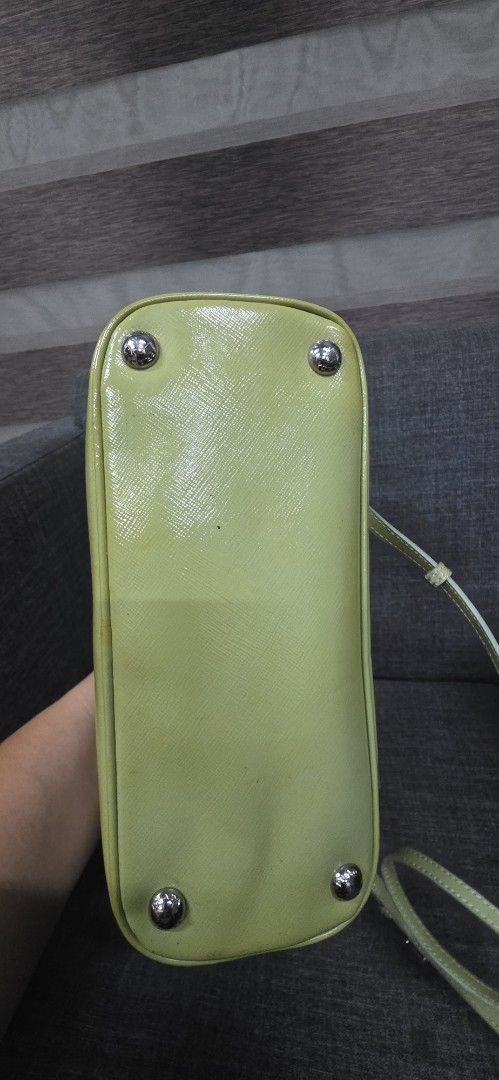 Prada Lime Green Patent Leather Studded Handbag (Category: Shoulder Bags) located in General Trias. Submitted by roselle2230 (Listing ID 1462416326, Image 3). Description: - Eye-catching lime green patent leather handbag - Adorned with sparkling green crystals and silver studs - Secure zipper closure - Features multiple interior compartments for organization - Includes a detachable strap for versatile carrying options - Perfect for adding a bold 