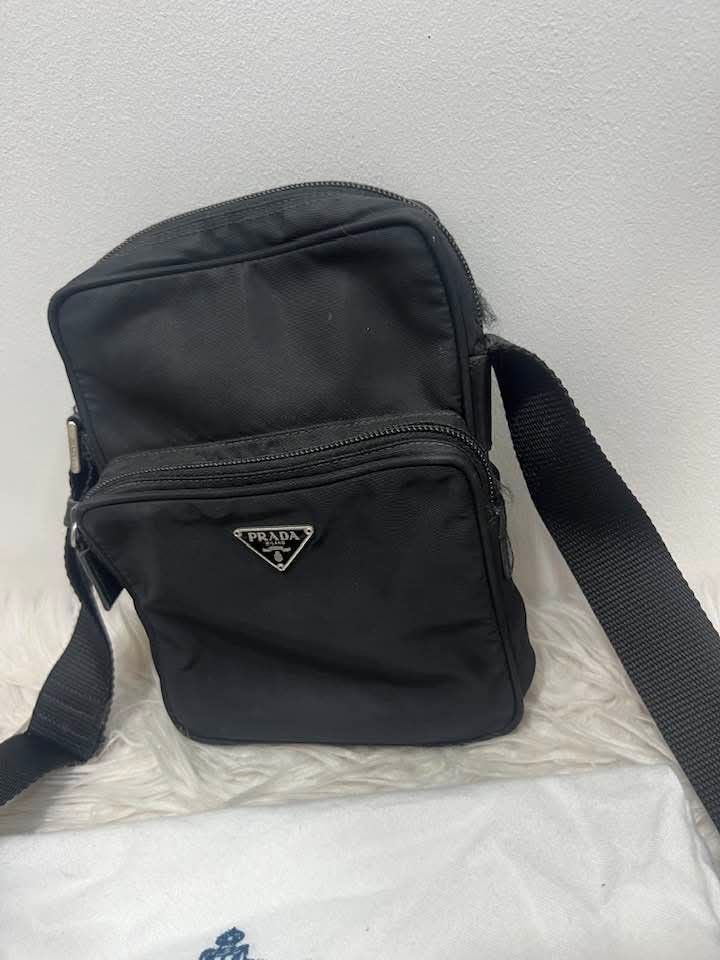 Prada Nylon Crossbody Bag Black (Category: Luxury Bags & Wallets) located in Manila. Submitted by rangya (Listing ID 1462336953, Image 1). Description: - Authentic Prada crossbody bag - Black nylon material - Front zip pocket - Main zip compartment - Adjustable shoulder strap - Silver tone hardware - Ideal for daily use - Comes with dust bag #10.