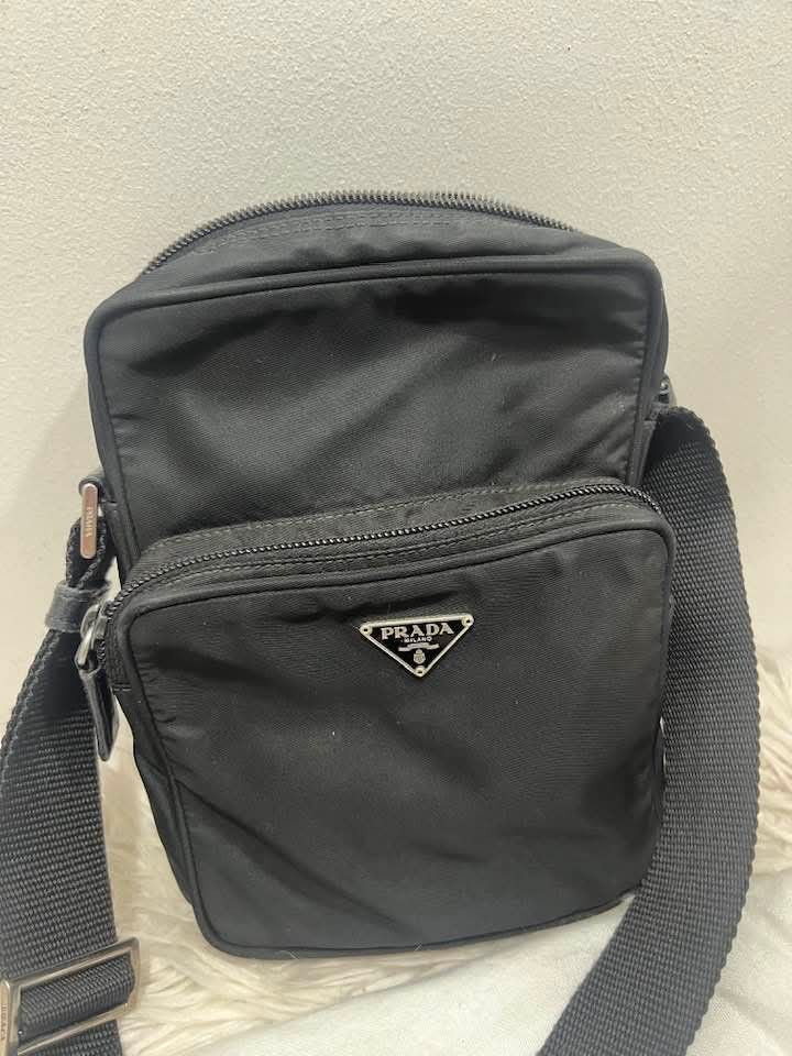 Prada Nylon Crossbody Bag Black (Category: Luxury Bags & Wallets) located in Manila. Submitted by rangya (Listing ID 1462336953, Image 2). Description: - Authentic Prada crossbody bag - Black nylon material - Front zip pocket - Main zip compartment - Adjustable shoulder strap - Silver tone hardware - Ideal for daily use - Comes with dust bag #10.