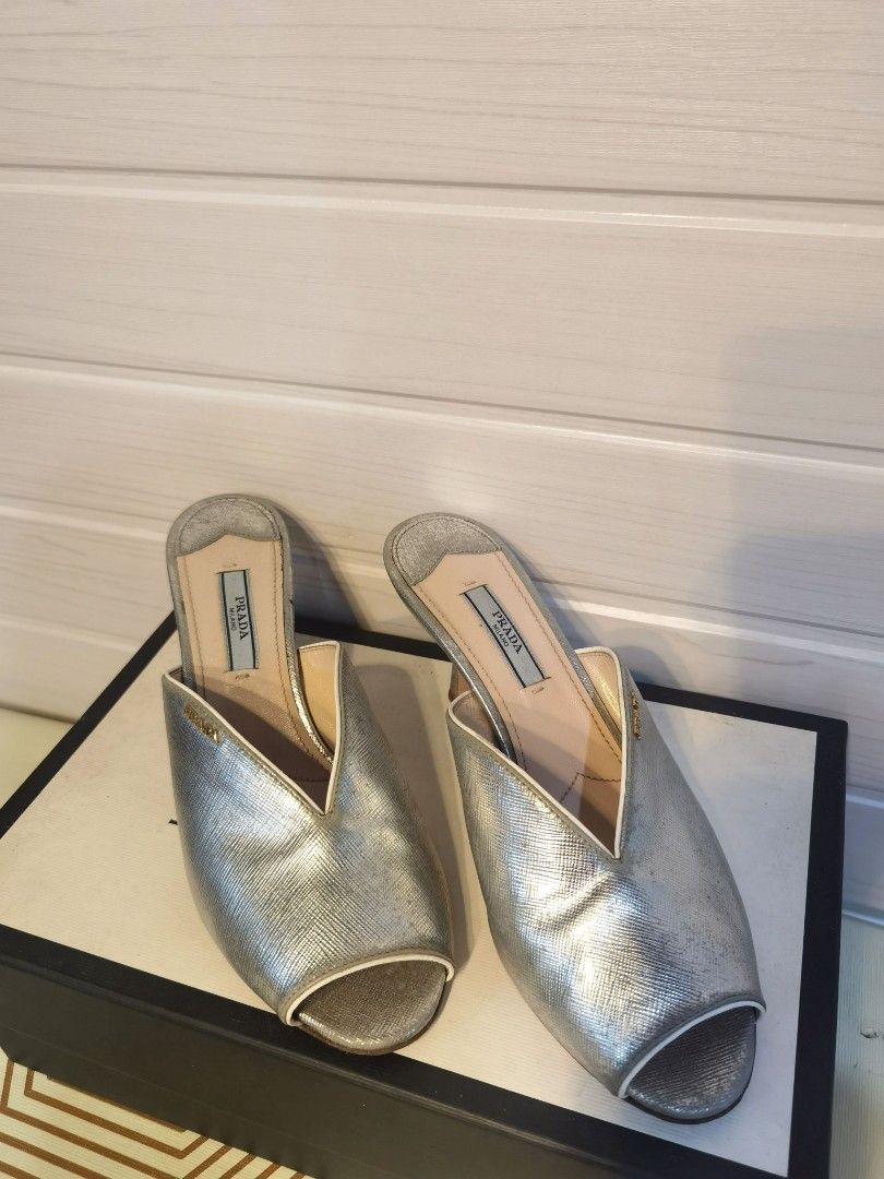 Prada Silver Metallic Leather Peep-Toe Mules Heels (Category: Heels) located in Tagaytay City. Submitted by SibsDeclutter4ever (Listing ID 1462404359, Image 2). Description: Authentic Silver metallic leather mules from Prada. Peep-toe design with a low heel. Easy slip-on style. The leather has a textured finish. Excellent used condition. Like new. Better in actual. LP. Selling low..