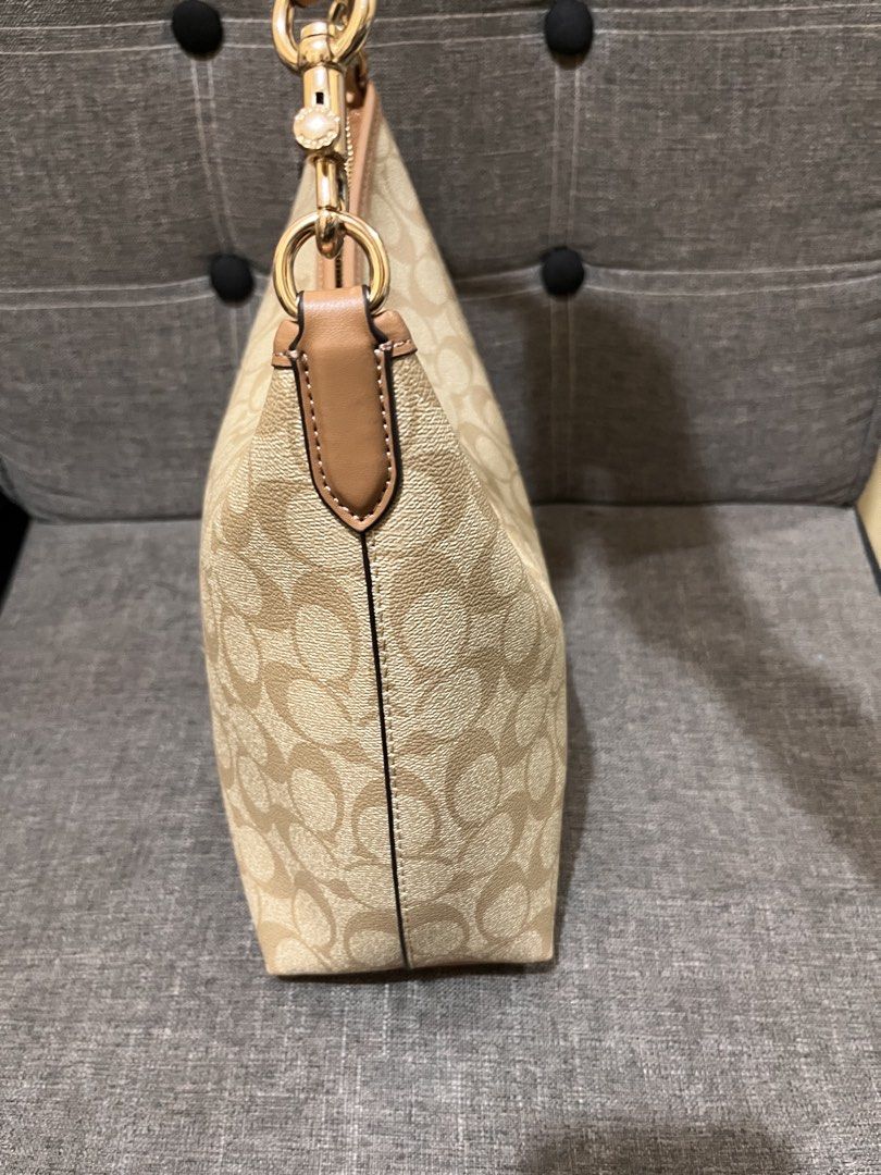 Preloved Coach Laurel from Hawaii (Category: Luxury Bags & Wallets) located in Manila. Submitted by zencat.93bfa9 (Listing ID 1462406671, Image 3). Description: - Classic Coach monogram shoulder bag - Tan and brown signature print - Light brown leather trim - Gold hardware details - Detachable crossbody strap included - Spacious interior - Ideal for everyday use.