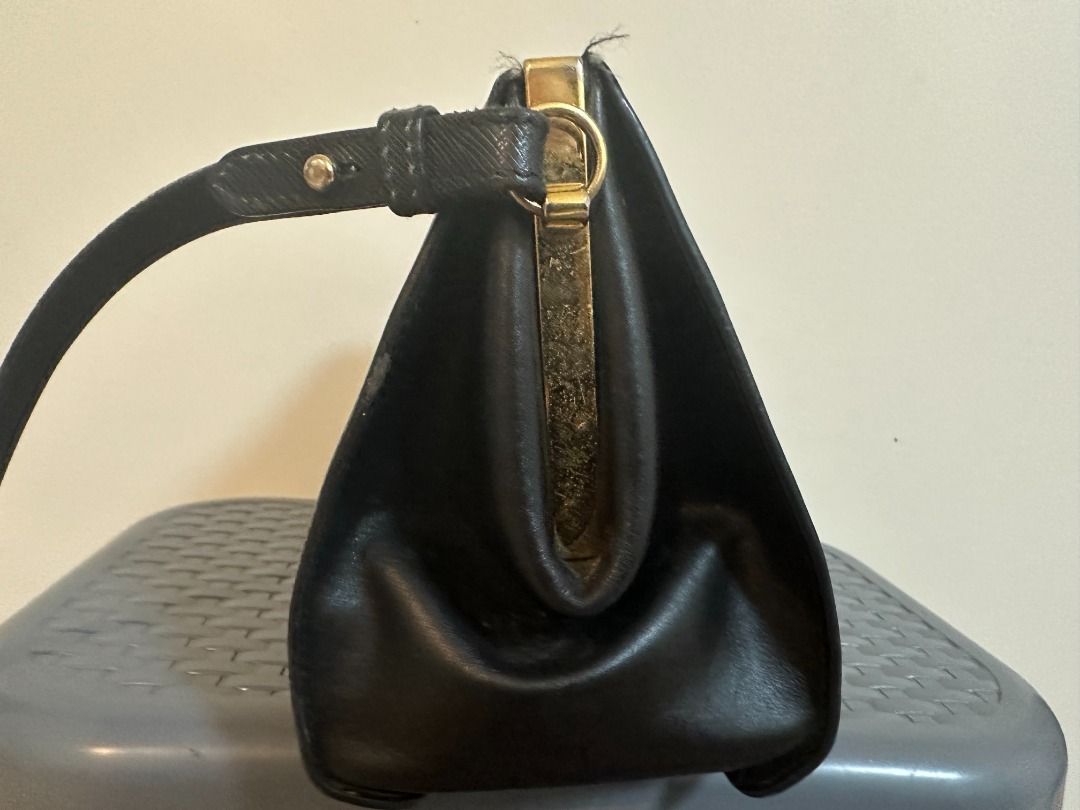 Pre-Owned Authentic Prada Light Frame Safiano Leather Bag (Category: Luxury Bags & Wallets) located in Pasay City. Submitted by sofiadeclutter_10 (Listing ID 1462337868, Image 3). Description: This is an pre-owned authentic PRADA Saffiano City Calfskin Light Frame Bag in Black. This chic bag is crafted from stylish saffiano cross-grain leather in black. The bag features an adjustable shoulder strap and gold hardware. The top opens to a black leat