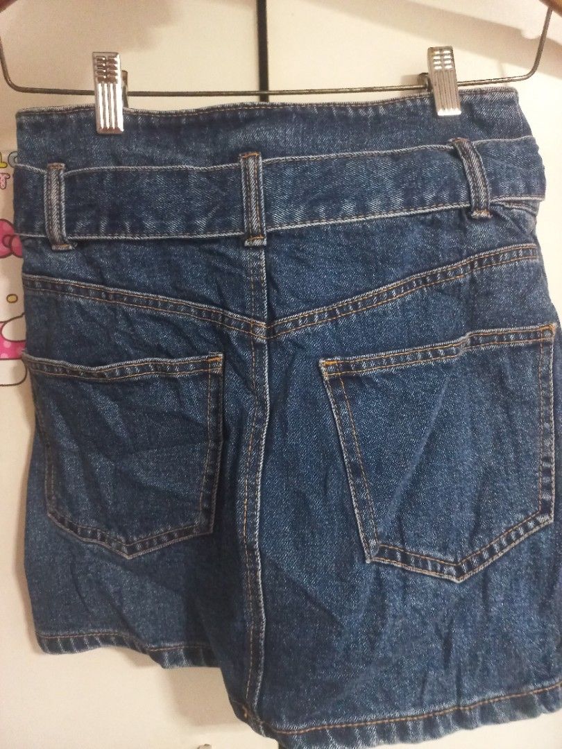 Pull & Bear Denim Skirt with Belt Size 28 (Category: Skirts) located in Manila. Submitted by maryjoyenc89891 (Listing ID 1462317724, Image 3). Description: - Pull & Bear blue denim skirt - Size 28 - Features a tie belt at the waist - Classic five-pocket styling - Made in Bangladesh - Ideal for casual wear.