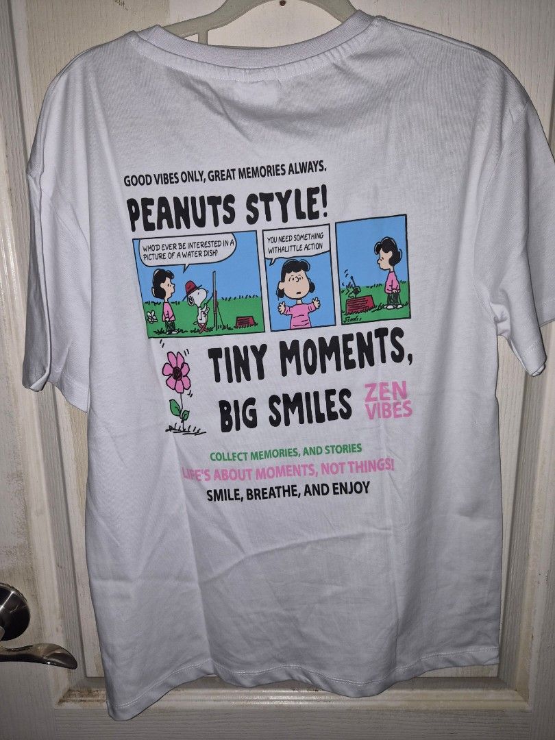 Pull & Bear Peanuts Style White Graphic T-Shirt (Category: Tshirts & Polo Shirts ) located in Taguig. Submitted by chloe_clothingco. (Listing ID 1462374059, Image 2). Description: - White graphic tee from Pull & Bear orig & length 26 x W 19 - Features a fun Peanuts comic strip design on the back - 'Peanuts Style!' text with a flower graphic on the front pocket area - Comfortable cotton material - Perfect for good vibes and collecting happy memori