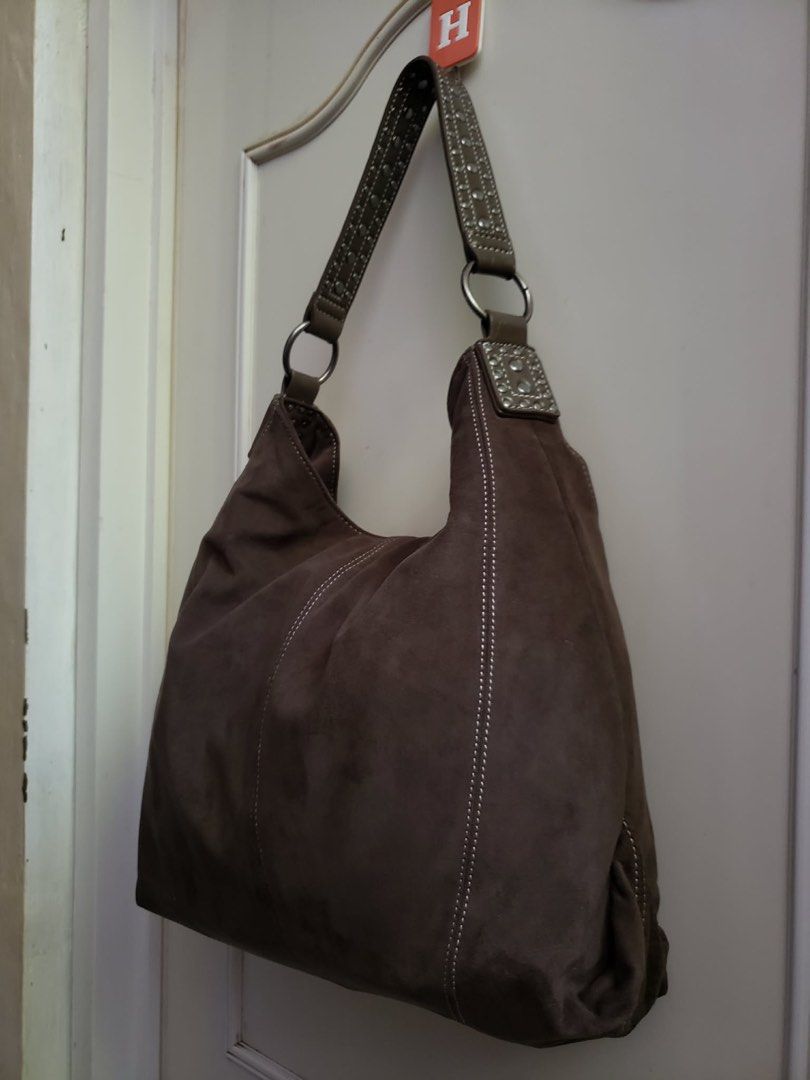 PULL& BEAR Brown Suede Hobo Bag with Studded Strap (Category: Shoulder Bags) located in Calapan. Submitted by shakalak (Listing ID 1462268213, Image 1). Description: - Chic brown suede hobo bag - Stylish studded strap with silver accents - Eye-catching white contrast stitching - Ample interior space for your essentials - Versatile design, perfect for daily use and complementing various outfits.