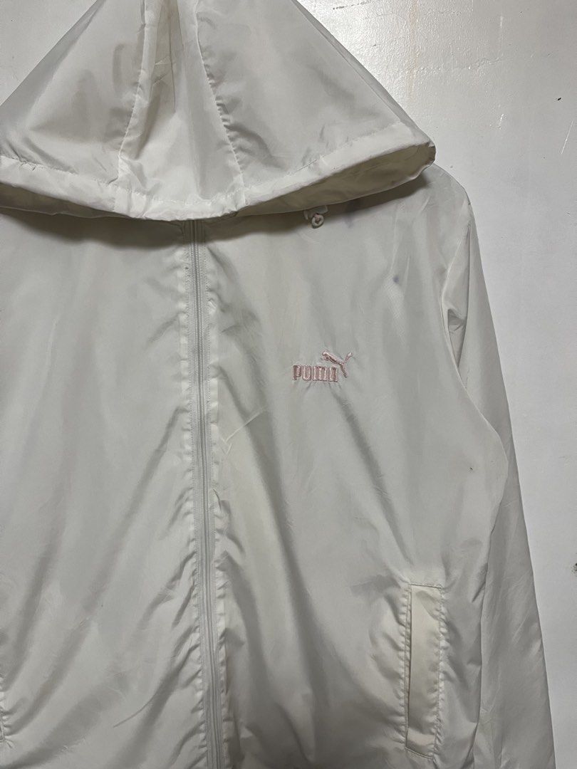Puma White Hooded Windbreaker Jacket XL (Category: Coats, Jackets and Outerwear) located in Tanza. Submitted by feliciano4108 (Listing ID 1462298215, Image 2). Description: - White Puma windbreaker jacket - Features a hood - Pink embroidered Puma logo on the chest - Two front pockets - Size XL - Ideal for casual wear and light outdoor activities.