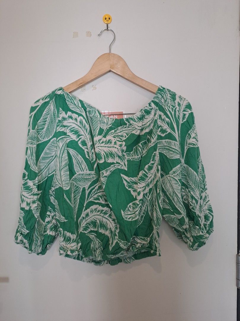 Rachel Zoe off shoulder (Category: Blouses) located in Manila. Submitted by joanbalde39643 (Listing ID 1462361680, Image 3). Description: This item is an off-the-shoulder tropical print crop top, by Rachel Zoe featuring a vibrant green and white palm leaf motif, relaxed elasticized sleeves, and a gathered waist..