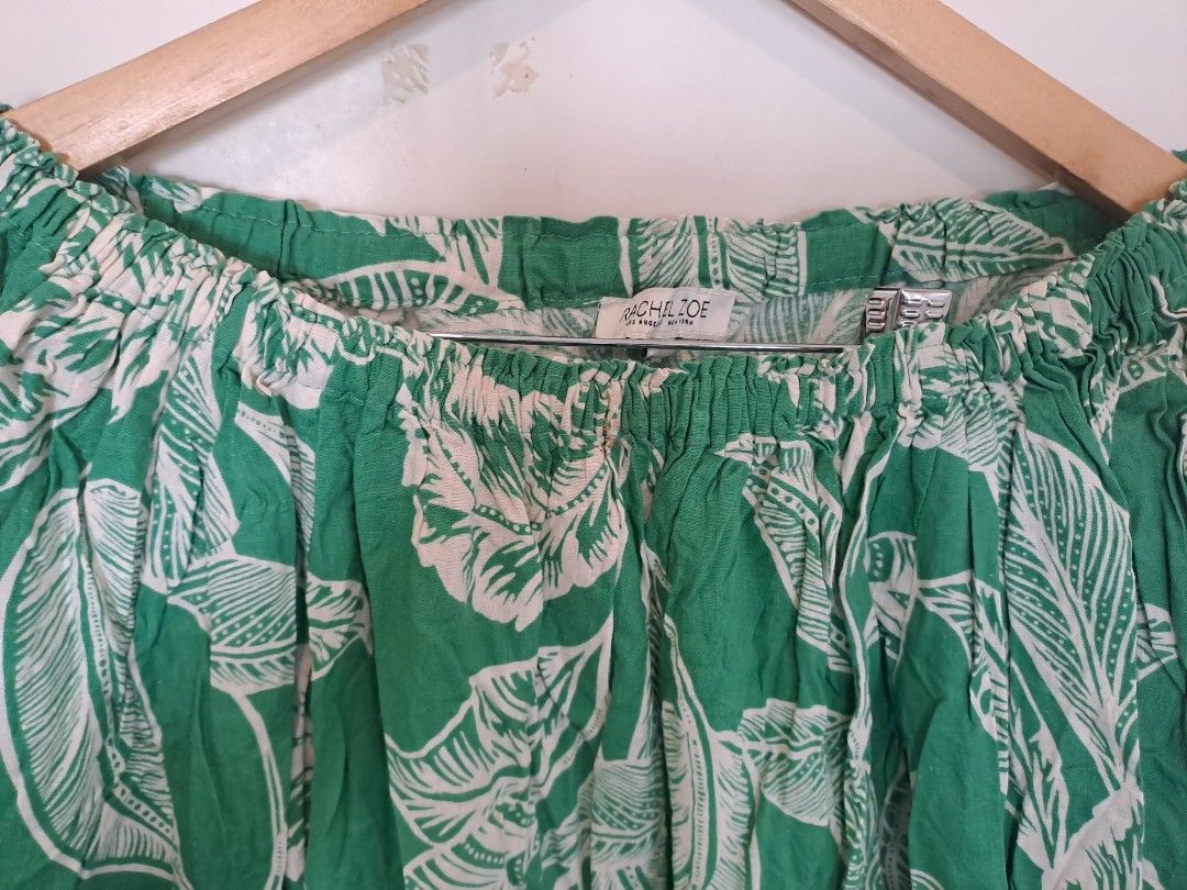 Rachel Zoe off shoulder (Category: Blouses) located in Manila. Submitted by joanbalde39643 (Listing ID 1462361680, Image 2). Description: This item is an off-the-shoulder tropical print crop top, by Rachel Zoe featuring a vibrant green and white palm leaf motif, relaxed elasticized sleeves, and a gathered waist..