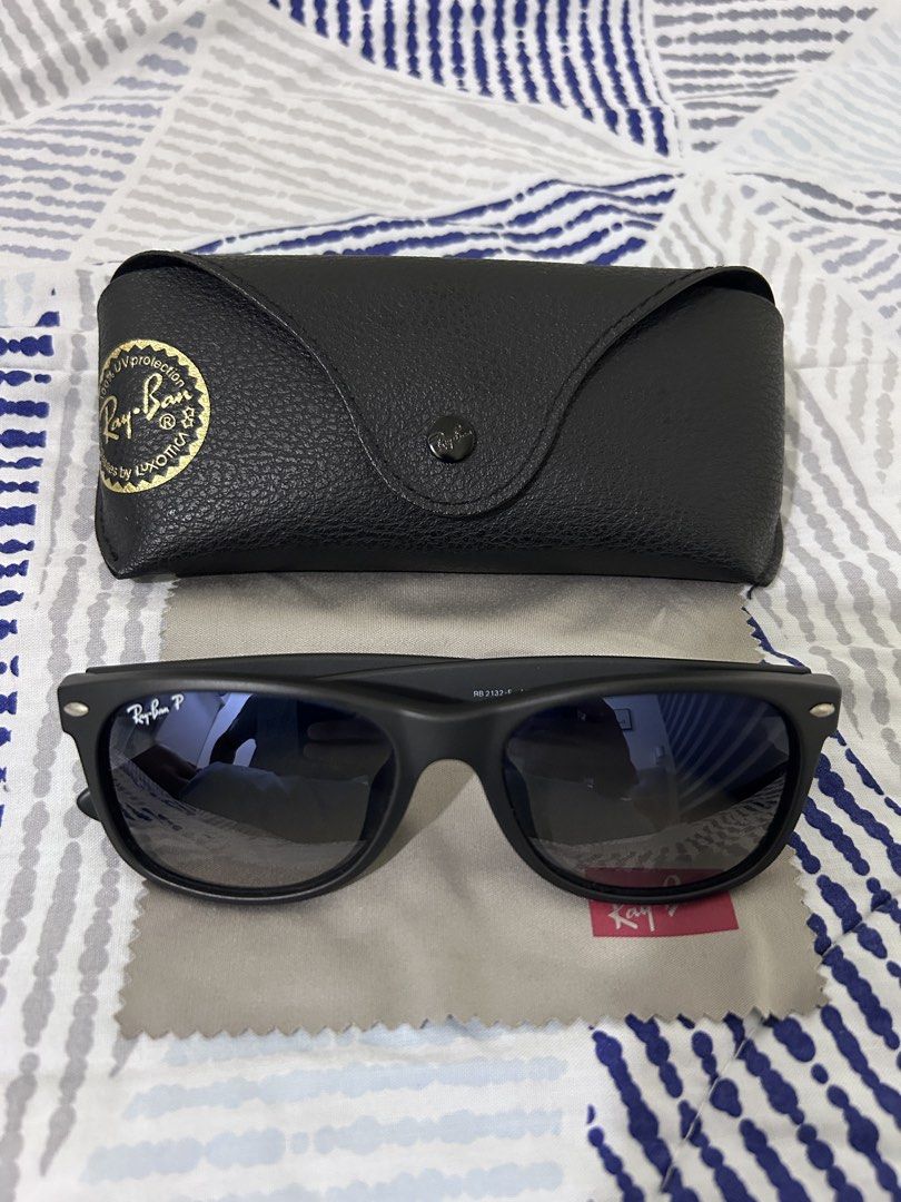 Ray-Ban New Wayfarer Polarized (Category: Sunglasses & Eyewear) located in Mandaluyong City. Submitted by nicko.montalbo (Listing ID 1462369125, Image 1). Description: - Authentic Ray-Ban New Wayfarer Sunglasses - Model: RB2132F - Polarized lenses for reduced glare - Made in Italy - Classic black frame with dark lenses - Includes original Ray-Ban case and cleaning cloth - Ideal for everyday wear - Price: Php 7,500 negotiable Meet ups: Mrt Boni, M