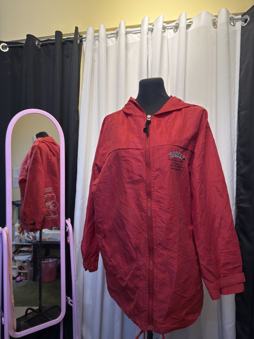 Red BABAL Jacket with Hood (Category: Coats, Jackets and Outerwear) located in Pulilan. Submitted by _sevegn (Listing ID 1462304968, Image 1). Description: - Red jacket with a hood - Zipper closure - 'BABAL' logo on the chest - Lightweight, slightly crinkled material - Drawstring at the bottom hem - Ideal for casual wear or as a light layer.