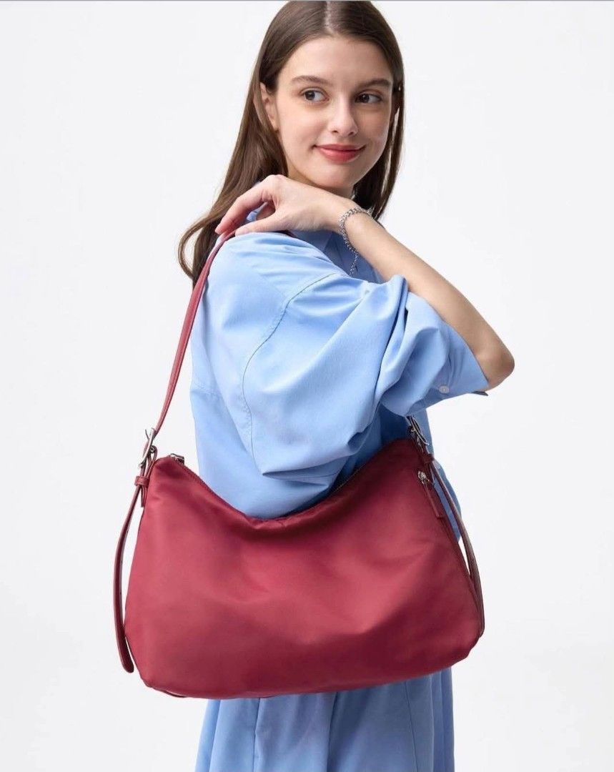 Red Nylon Shoulder Bag with Leather Straps (Category: Shoulder Bags) located in Manila. Submitted by tokyo_thv (Listing ID 1462434515, Image 1). Description: - Red nylon shoulder bag - Genuine leather straps - Silver-tone hardware - Adjustable strap with buckle - Soft, slouchy silhouette - Spacious interior - Ideal for everyday carry.