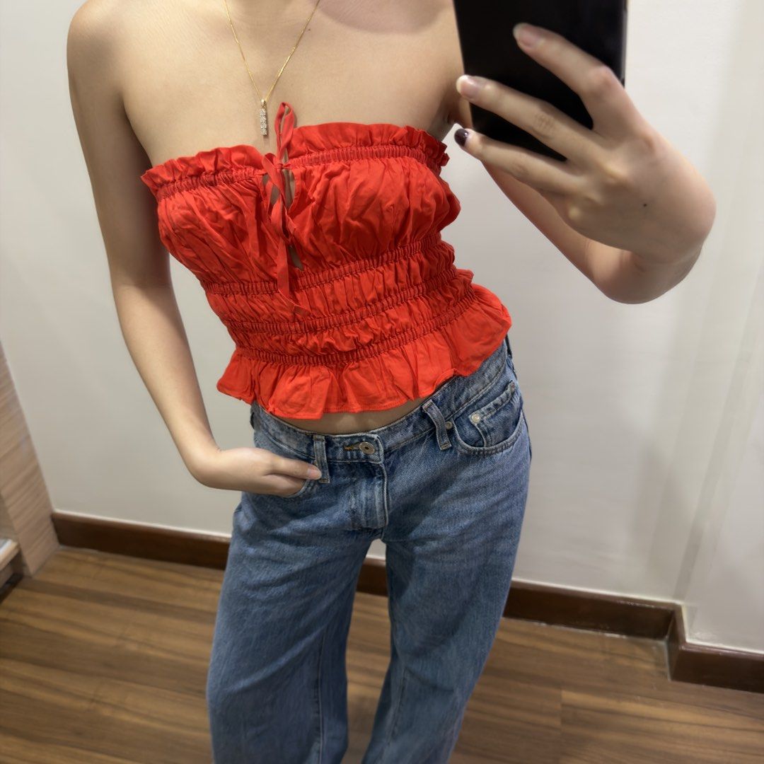 H&M Red Smocked Tube Top (Category: Sleeveless) located in Quezon City. Submitted by miumuse_ (Listing ID 1462299340, Image 2). Description: - Cute red smocked tube top - Features a tie front detail - Ruffled hem for a stylish finish - Versatile: pairs well with jeans or shorts - Ideal for summer days or nights out - Very stretchy and comfortable for all-day wear - Easy to wear and style.