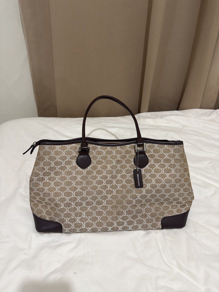 RIONI Monogram Tote Bag (Category: Tote Bags) located in Mandaluyong City. Submitted by stylececilia.ph (Listing ID 1462317885, Image 2). Description: - RIONI monogram tote bag - Classic brown and beige pattern - Genuine leather trim and handles - Secure zipper closure - Multiple interior pockets for organization - Spacious main compartment - Ideal everyday bag.