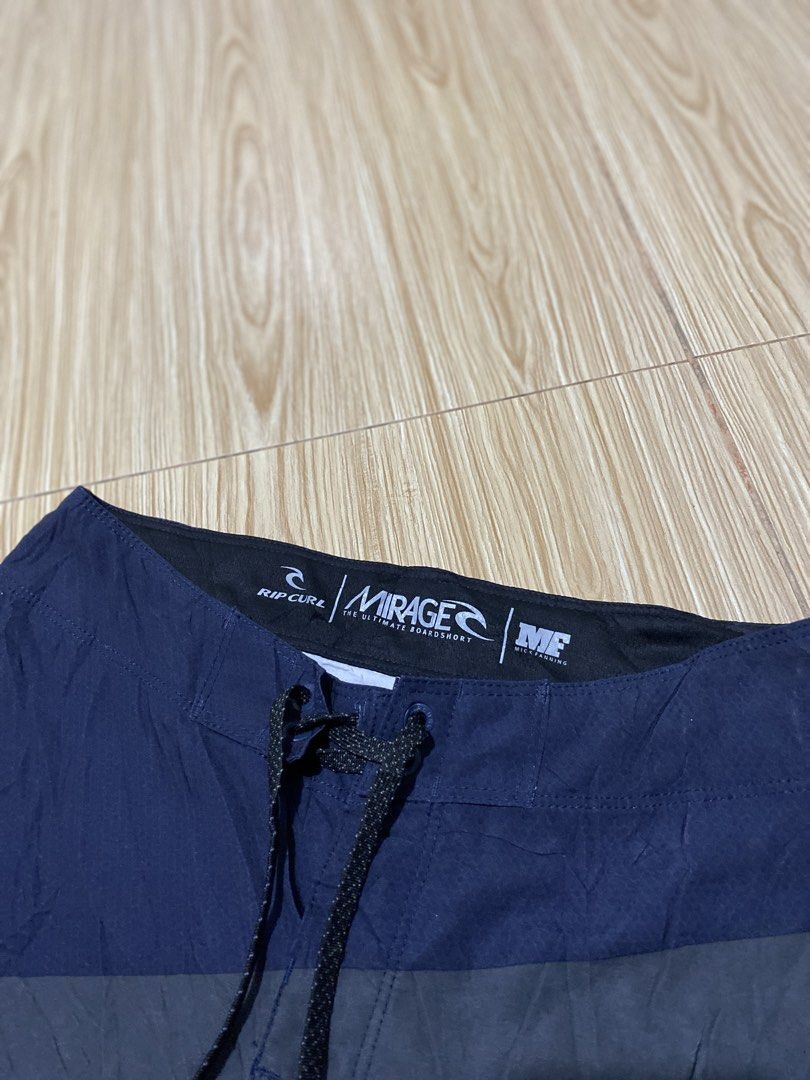 Rip Curl Mirage Boardshorts (Category: Swim Trunks & Board Shorts) located in Davao. Submitted by jayelcarba61168 (Listing ID 1462277038, Image 2). Description: - Rip Curl Mirage boardshorts - Stylish navy, red, grey, and white striped design - Comfortable elastic waistband with adjustable drawstring - Made with quick-drying material - Ideal for swimming, surfing, or beach activities.
