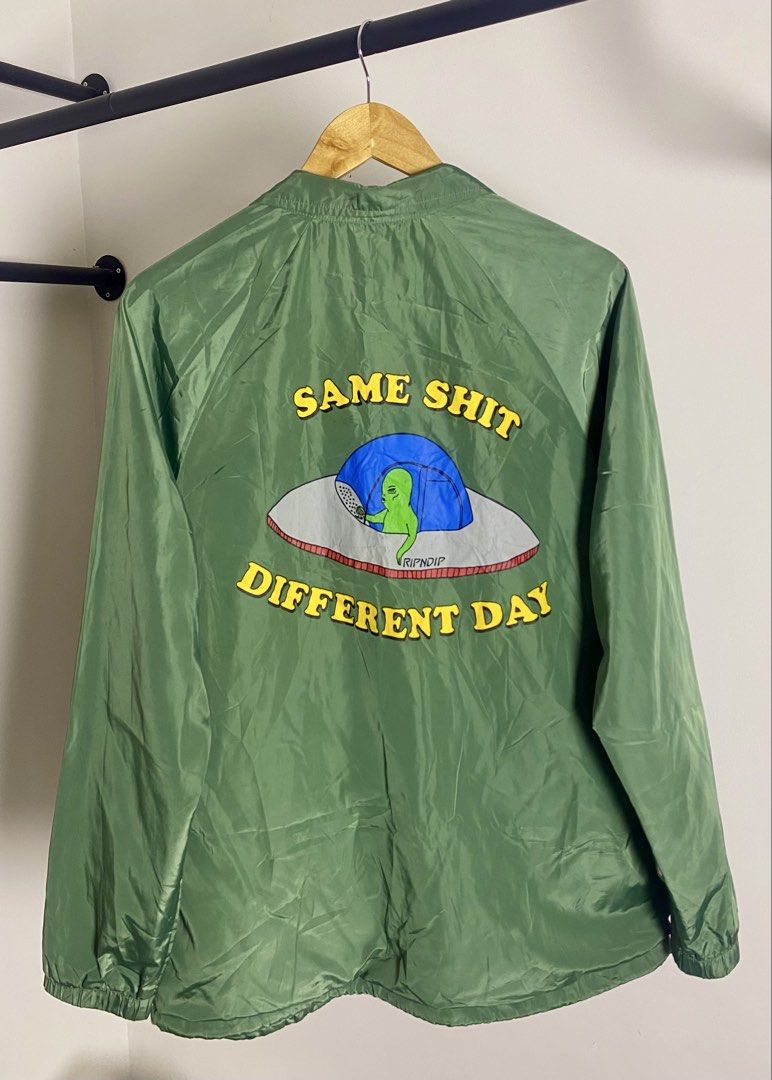 RIPNDIP "Same Shit Different Day" Coach Jacket Green Size M (Category: Coats, Jackets and Outerwear) located in Quezon City. Submitted by getgetpao (Listing ID 1462434928, Image 1). Description: Size on tag Medium 27.5”Lx22.5”W Issue: damage print (see photos) print transfer (PM send ko photos) Very good condition - Green RIPNDIP Coach Jacket - Size: Medium (M) - Iconic 'Same Shit Different Day' graphic on back - Features alien in a UFO design - 