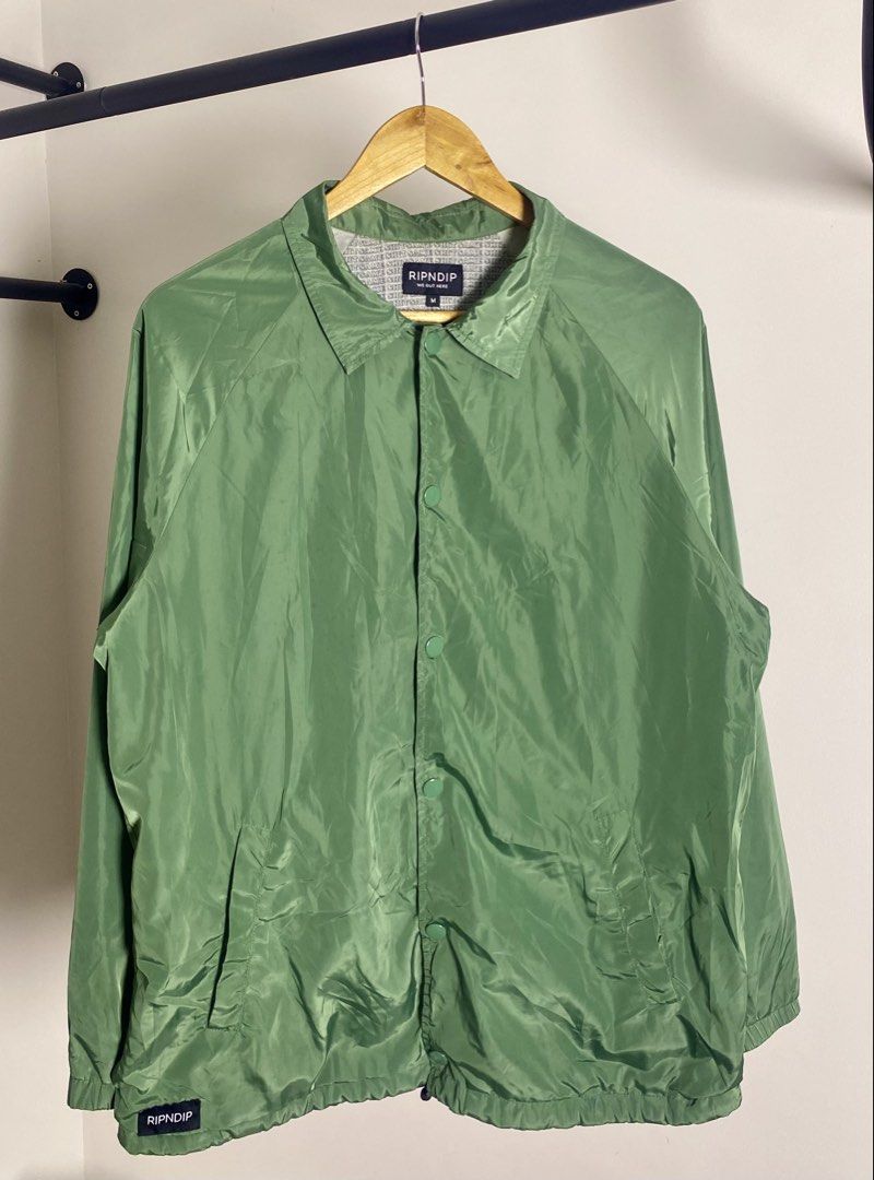 RIPNDIP "Same Shit Different Day" Coach Jacket Green Size M (Category: Coats, Jackets and Outerwear) located in Quezon City. Submitted by getgetpao (Listing ID 1462434928, Image 2). Description: Size on tag Medium 27.5”Lx22.5”W Issue: damage print (see photos) print transfer (PM send ko photos) Very good condition - Green RIPNDIP Coach Jacket - Size: Medium (M) - Iconic 'Same Shit Different Day' graphic on back - Features alien in a UFO design - 