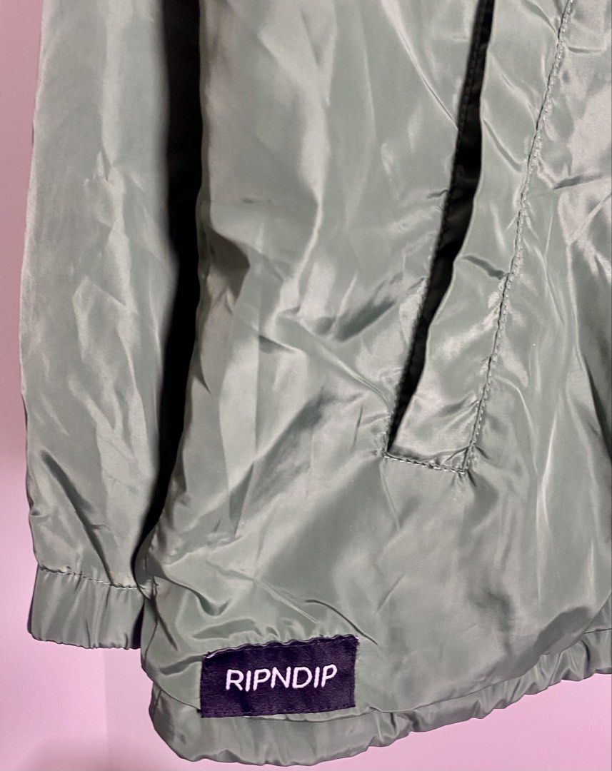 RIPNDIP "Same Shit Different Day" Coach Jacket Green Size M (Category: Coats, Jackets and Outerwear) located in Quezon City. Submitted by getgetpao (Listing ID 1462434928, Image 3). Description: Size on tag Medium 27.5”Lx22.5”W Issue: damage print (see photos) print transfer (PM send ko photos) Very good condition - Green RIPNDIP Coach Jacket - Size: Medium (M) - Iconic 'Same Shit Different Day' graphic on back - Features alien in a UFO design - 