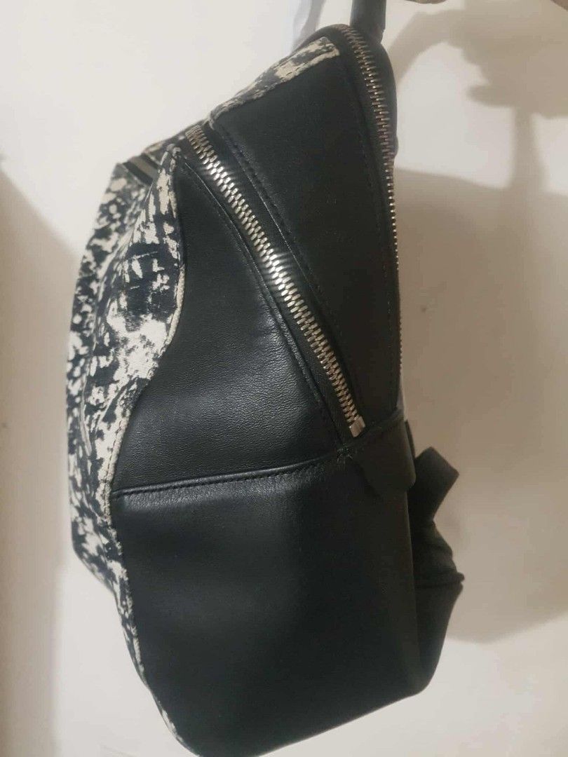 Rouge & lounge Backpack (Category: Luxury Bags & Wallets) located in Marilao. Submitted by joycehart (Listing ID 1462287697, Image 3). Description: - Eye-catching black and white splatter print - Genuine black leather trim - Secure zipper closure - Comfortable top handles - Surprisingly spacious interior - Ideal for everyday errands and style.
