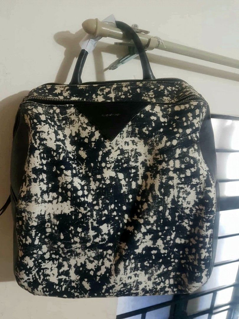 Rouge & lounge Backpack (Category: Luxury Bags & Wallets) located in Marilao. Submitted by joycehart (Listing ID 1462287697, Image 1). Description: - Eye-catching black and white splatter print - Genuine black leather trim - Secure zipper closure - Comfortable top handles - Surprisingly spacious interior - Ideal for everyday errands and style.