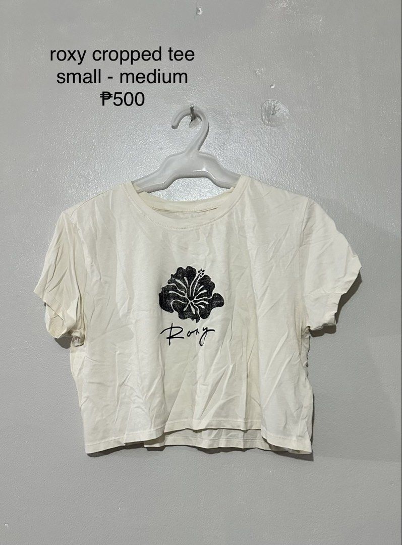 Roxy Cropped Tee - White with Black Flower Print (Category: Shirts) located in Manila. Submitted by vhhhhhhh (Listing ID 1462408561, Image 1). Description: - Brand: Roxy - Style: Cropped T-shirt - Color: White - Graphic: Black hibiscus flower with Roxy logo - Size: Fits Small to Medium - Occasion: Casual wear.