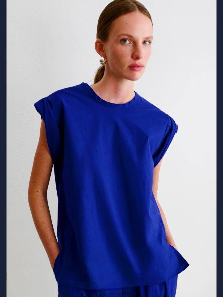 Royal blue tops (Category: Blouses) located in Cabanatuan. Submitted by miss.maia (Listing ID 1462423088, Image 1). Description: This royal blue short-sleeve top from the brand Sybaris features a clean, boat-neck collar design with extended shoulder/cap sleeves. It provides a simple, modern look perfect for both casual everyday wear and business-casual layering..