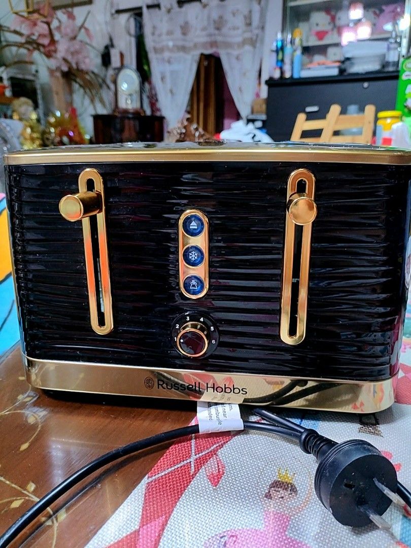 Russell Hobbs Toaster with 4 Functions (Category: Ovens & Toasters) located in Baliuag. Submitted by marieannfernando23 (Listing ID 1462326381, Image 2). Description: - Stylish black and gold Russell Hobbs toaster - 4 convenient functions: Cancel, Defrost, Reheat - Adjustable browning control dial (1-6) for your perfect toast - Automatic pop-up lever for easy toast retrieval - Adds a sleek touch to any kitchen counter - Ideal for making delicious