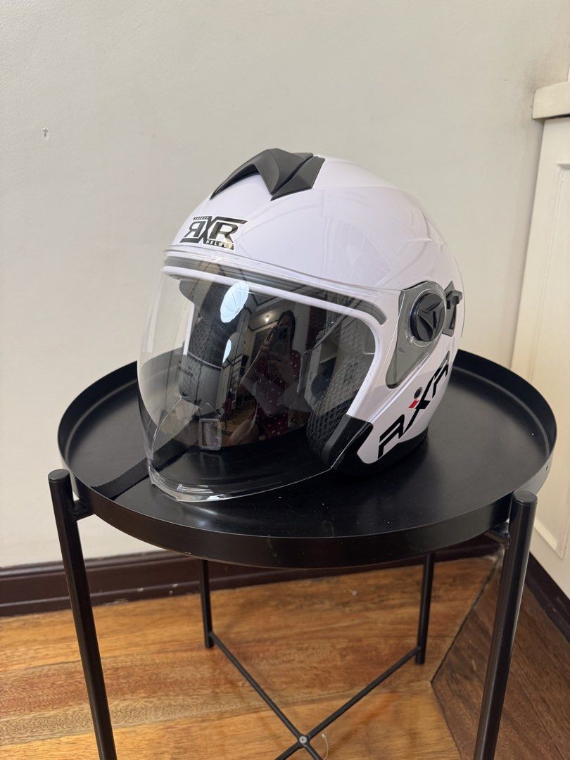 RXR Titanium Motorcycle Helmet with Anti-Scratch Visor (Category: Helmets and other Riding Gears) located in Manila. Submitted by supremeloved (Listing ID 1460954172, Image 1). Description: -original price: 729 -selling price: 400 - Glossy White RXR helmet (half face) -Used for taking videos lang - Titanium design on the back - Anti-scratch visor - Clean and well-padded interior - Quick-release buckle strap - Ready for your next ride!.