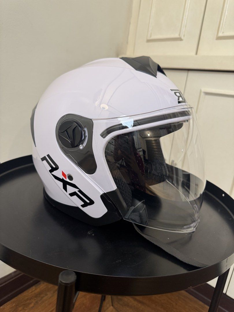 RXR Titanium Motorcycle Helmet with Anti-Scratch Visor (Category: Helmets and other Riding Gears) located in Manila. Submitted by supremeloved (Listing ID 1460954172, Image 3). Description: -original price: 729 -selling price: 400 - Glossy White RXR helmet (half face) -Used for taking videos lang - Titanium design on the back - Anti-scratch visor - Clean and well-padded interior - Quick-release buckle strap - Ready for your next ride!.