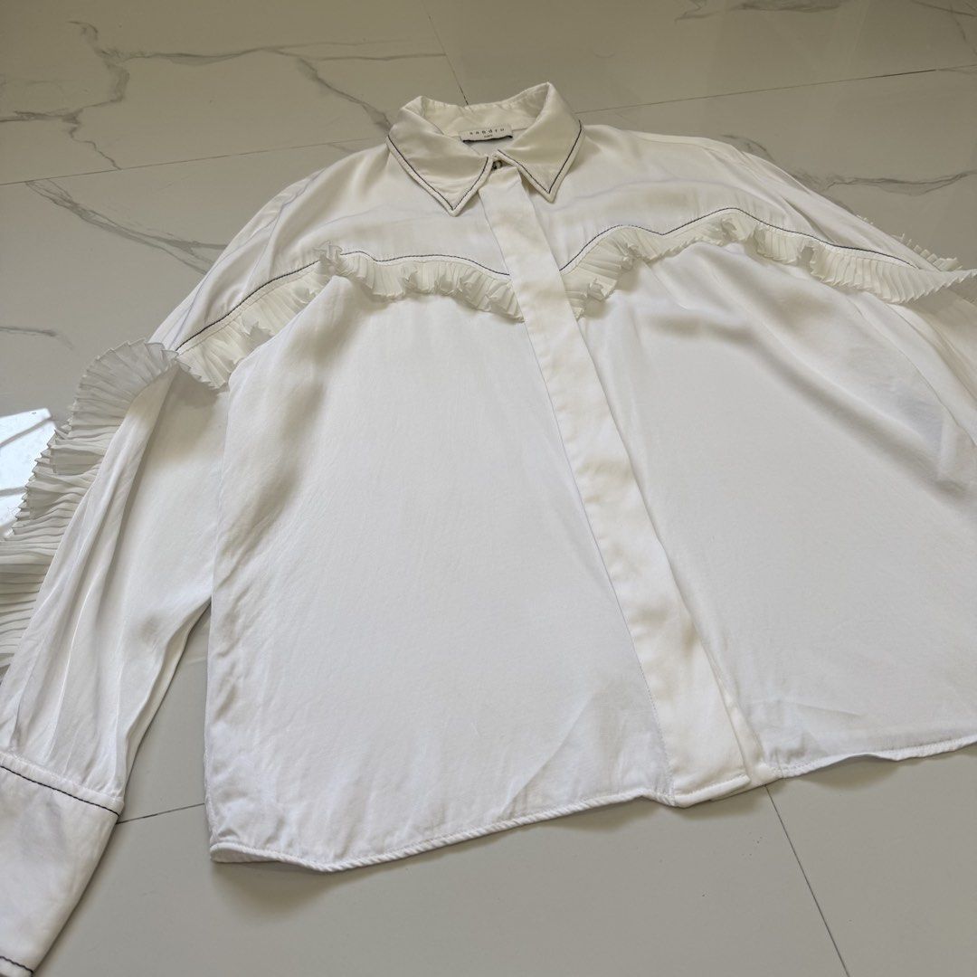 Sandro Ruffle Blouse Long Sleeves (Category: Longsleeves) located in Santo Tomas. Submitted by the580closet (Listing ID 1462364129, Image 2). Description: - Size: 3 19 inches - chest 26 inches - length 17 inches - shoulder 23 inches - sleeves.
