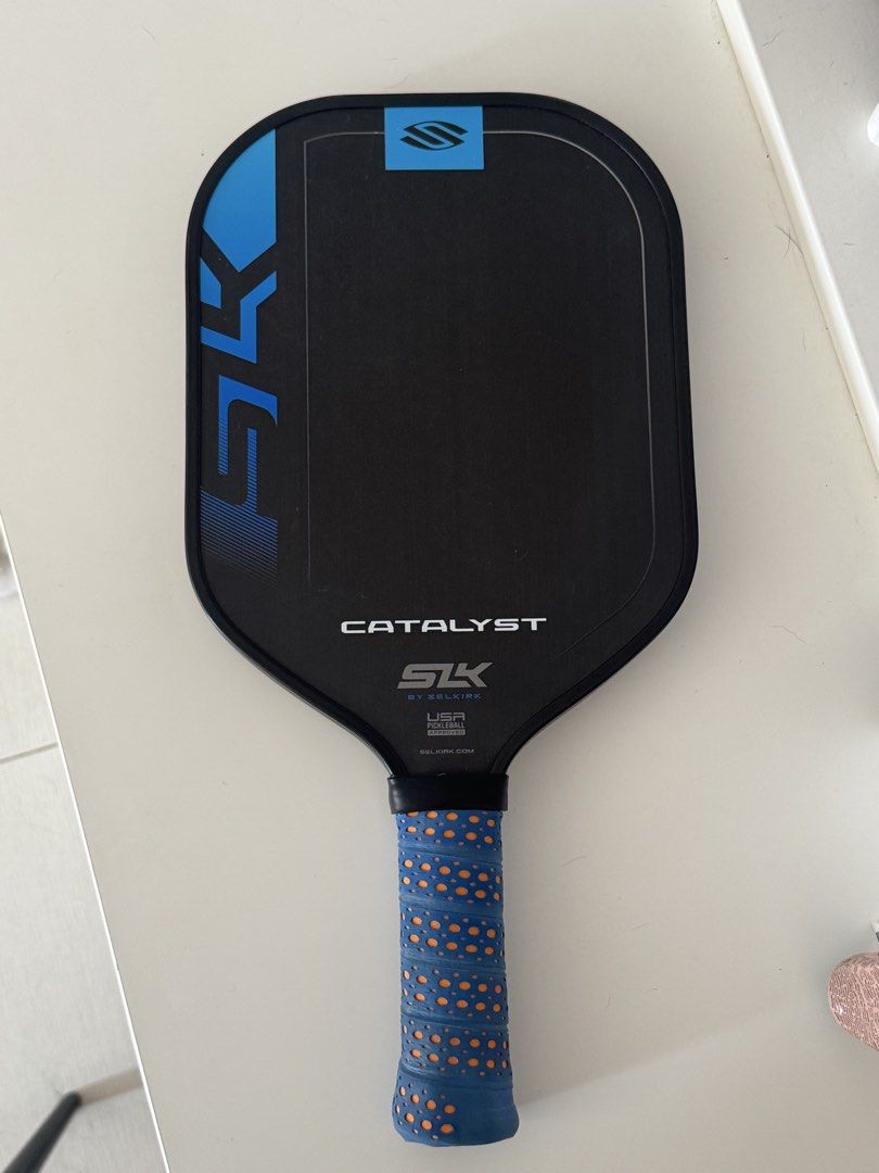 Selkirk SLK Catalyst Pickleball Paddle (Category: Racket and Ball Sports) located in Las Pinas. Submitted by liyadeclutters (Listing ID 1462314172, Image 1). Description: Raw carbon fiber Used for 1 month only (casual play) Grip taped upon purchase. Never removed Condition: Minor scuff marks on edge from normal play Bought for 3,400 at Toby’s .