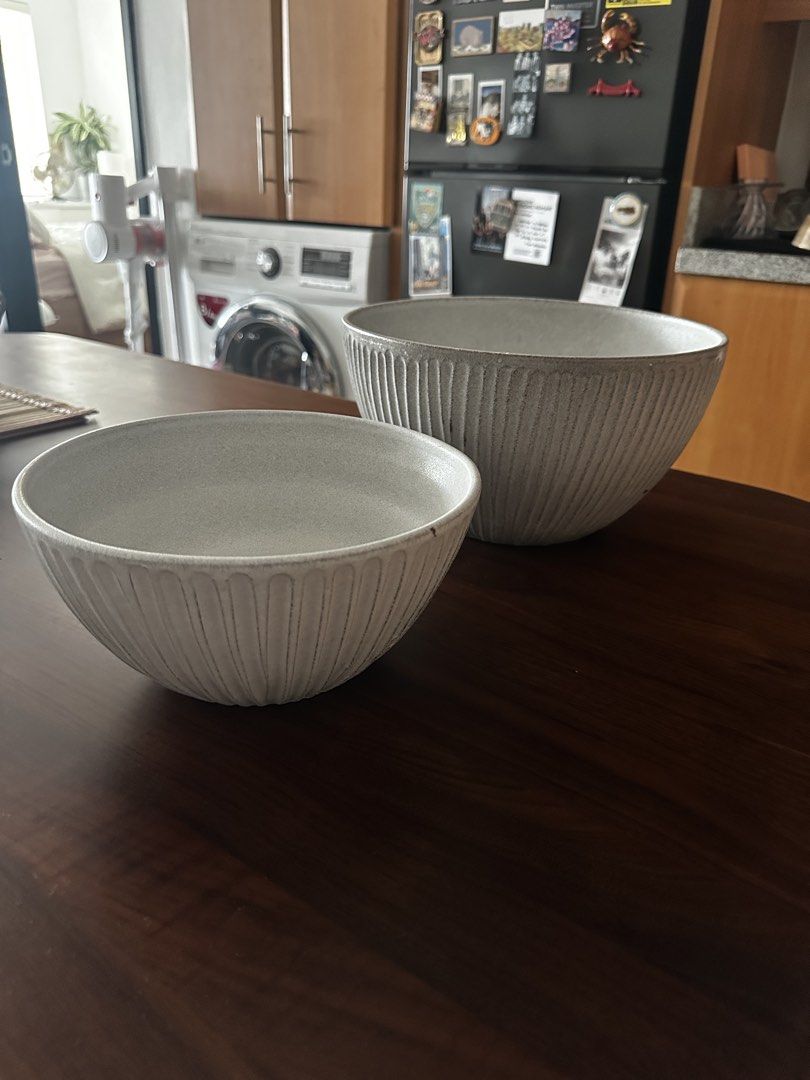 Set of 2 Grey Ceramic Serving Bowls (Category: Dinnerware & Cutlery) located in Quezon City. Submitted by lkespiritu (Listing ID 1462319016, Image 1). Description: - Set of 2 grey ceramic serving bowls - Features a ribbed texture on the exterior - Ideal for serving salads, snacks, or as decorative pieces - Includes one larger bowl (positioned behind the smaller one).