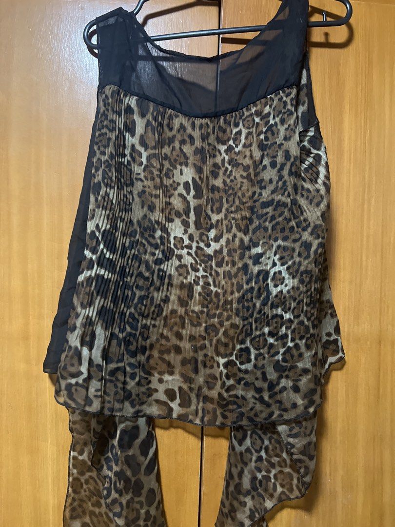 Sheer Leopard Print Pleated Top with Draping (Category: Blouses) located in Pasig City. Submitted by zebteashoppe01 (Listing ID 1462403354, Image 2). Description: - Sheer black fabric - Leopard print pleated front panel - Draping chiffon side panels - Square neckline - Versatile for layering or standalone wear - Unique and eye-catching design Small to medium 09096535540 Gcash mop Jnt pasig.
