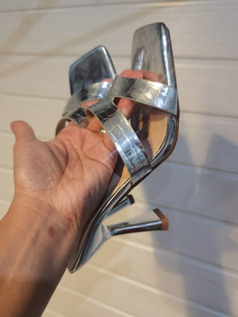 Shein Silver Square Toe Heeled Mules (Category: Heels) located in Tagaytay City. Submitted by SibsDeclutter4ever (Listing ID 1462399358, Image 3). Description: Good as new. used once. So signs of usage. Silver heeled mules with a square toe. Features two straps across the foot, one with a croc-embossed texture. The heel has a unique sculpted shape. Great for dressing up an outfit..