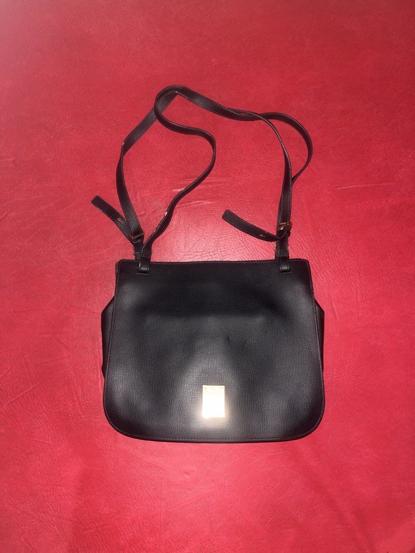 Shoulder/ Cross-body leather bag (Category: Cross-body Bags) located in Davao. Submitted by janna_soleil (Listing ID 1462290876, Image 1). Description: black leather crossbody or shoulder bag with an adjustable strap and a metallic clasp closure on the front flap.