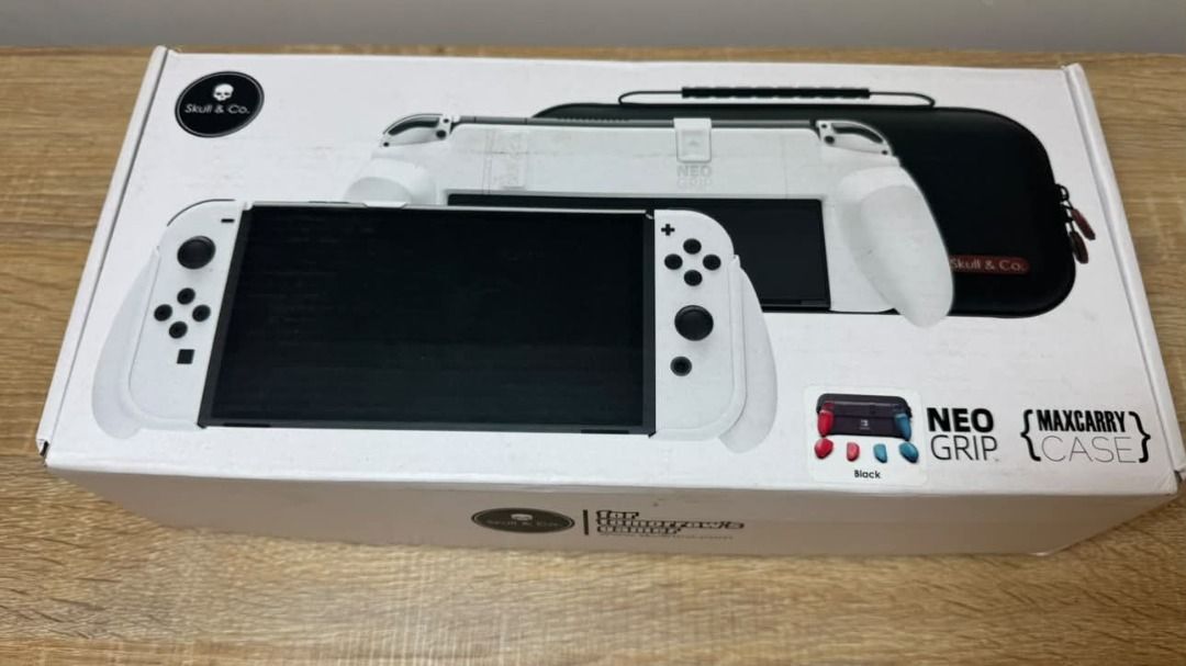 Skull & Co. NeoGrip Case for Nintendo Switch (Category: Cases & Covers) located in Taguig. Submitted by aaron.d28 (Listing ID 1462427103, Image 3). Description: - Skull & Co. NeoGrip Case for Nintendo Switch - Color: Black - Durable hard shell protection - Designed to fit Switch with grips attached - Spacious interior for accessories - Includes original packaging - Ideal for travel and on-the-go gaming.
